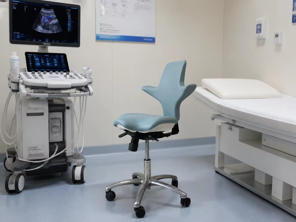 DTL-ZY-24 stool in use in an ultrasound examination room, beside a diagnostic ultrasound console and an examination couch