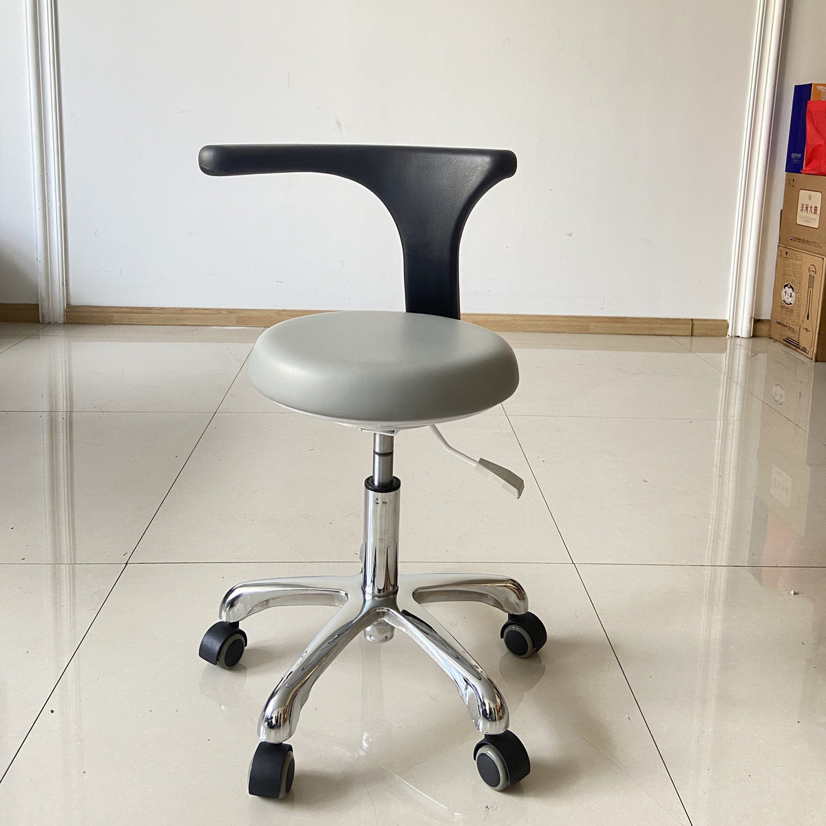 DTL-ZY-01 assistant chair in grey upholstery on a chrome base, photographed on site
